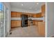 Open eat-in kitchen with ample wood cabinetry, tile floors, and stainless appliances at 1552 Live Oak Rd, Castle Rock, CO 80104