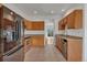 Well-lit kitchen features stainless steel appliances, granite countertops, tile floors, and wine cooler at 1552 Live Oak Rd, Castle Rock, CO 80104