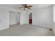 Bright bedroom featuring plush carpeting, ceiling fan, and closet space at 1552 Live Oak Rd, Castle Rock, CO 80104