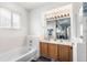 Bright bathroom features double sinks, a large mirror and ample natural light at 16040 E 98Th Ave, Commerce City, CO 80022