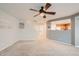 Open living room with neutral decor, carpeted floors, and a ceiling fan at 5447 S Qautar Ct, Aurora, CO 80015