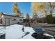 Backyard with detached garage and snow at 1961 W Kentucky Ave, Denver, CO 80223