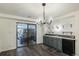 Basement bar with gray cabinets, a wet bar, and sliding door access at 1961 W Kentucky Ave, Denver, CO 80223