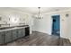 Basement bar with gray cabinets, a mini-fridge and a wet bar at 1961 W Kentucky Ave, Denver, CO 80223