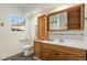 Clean bathroom, wood vanity, and a shower/tub combo at 1961 W Kentucky Ave, Denver, CO 80223