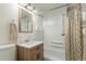 Clean bathroom with light wood vanity and tub shower at 1961 W Kentucky Ave, Denver, CO 80223