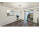 Dining room with dark hardwood floors and a view into the kitchen at 1961 W Kentucky Ave, Denver, CO 80223