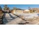 House exterior and driveway with snow at 1961 W Kentucky Ave, Denver, CO 80223