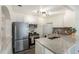 Modern kitchen with stainless steel appliances and granite countertops at 1961 W Kentucky Ave, Denver, CO 80223