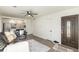 Living room features hardwood floors, a view of the kitchen, and access to the front door at 1961 W Kentucky Ave, Denver, CO 80223