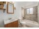 Cozy bathroom with a vanity, medicine cabinet, and a shower-tub combo, complete with tile accents at 757 Norfolk Way, Aurora, CO 80011