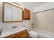 Well-lit bathroom featuring a vanity, mirrored cabinet, and a tiled shower/tub combination at 757 Norfolk Way, Aurora, CO 80011