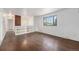 Bright living room featuring hardwood floors, built-in shelving, and large windows at 757 Norfolk Way, Aurora, CO 80011