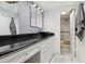 Bathroom with black vessel sink, white cabinets, and tiled floors at 9725 E Harvard Ave # 349, Denver, CO 80231