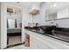 Bathroom with black vessel sink, white cabinets, and tiled floors at 9725 E Harvard Ave # 349, Denver, CO 80231