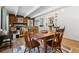 Bright dining area with wood table and chairs, adjacent to living room and kitchen at 9725 E Harvard Ave # 349, Denver, CO 80231