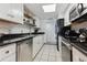 Modern kitchen with white cabinets, black appliances, and granite countertops at 9725 E Harvard Ave # 349, Denver, CO 80231