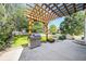Outdoor living with a patio, pergola, stainless steel grill, and lush green lawn creates a perfect retreat at 10289 Dresden St, Firestone, CO 80504