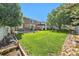 Expansive backyard with a well-maintained lawn, a charming pergola, and a privacy fence enhances outdoor living at 10289 Dresden St, Firestone, CO 80504