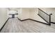 Spacious finished basement with wood floors, a wet bar, and stairs at 10289 Dresden St, Firestone, CO 80504