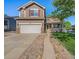 Charming two-story home featuring a well-manicured lawn, inviting porch, and a two-car garage at 10289 Dresden St, Firestone, CO 80504