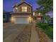 Charming two-story home featuring a well-manicured lawn, inviting porch, and a two-car garage at 10289 Dresden St, Firestone, CO 80504