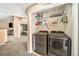 Practical laundry area with shelving and washer and dryer hookups, providing efficient storage and convenience at 10289 Dresden St, Firestone, CO 80504