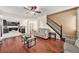 Spacious living room showcasing hardwood floors, neutral tones, and access to the kitchen at 10289 Dresden St, Firestone, CO 80504