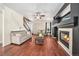 Cozy living room with hardwood floors, a fireplace, and neutral-colored furniture at 10289 Dresden St, Firestone, CO 80504
