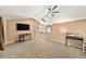 Bright loft area with plush carpeting, a ceiling fan, and convenient access to other areas of the home at 10289 Dresden St, Firestone, CO 80504