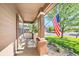 Inviting front porch with an American flag and a glimpse of the well-kept neighborhood at 10289 Dresden St, Firestone, CO 80504