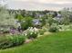 A lush green backyard with meticulously landscaped flower beds and vibrant flower groupings at 16261 W Ellsworth Ave, Golden, CO 80401