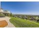 Sprawling backyard offers beautiful mountain views, green grass, and mature landscaping at 16261 W Ellsworth Ave, Golden, CO 80401