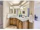 Spacious bathroom with double sink vanity, granite countertop, and decorative mirrors at 16261 W Ellsworth Ave, Golden, CO 80401