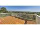 An outdoor deck showing beautiful views of green hills and mountains under a clear blue sky at 16261 W Ellsworth Ave, Golden, CO 80401