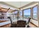 Bright dining area boasts large windows with expansive views and a modern chandelier at 16261 W Ellsworth Ave, Golden, CO 80401