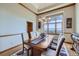 Elegant dining room with a wooden table, upholstered chairs, and a large window with a view at 16261 W Ellsworth Ave, Golden, CO 80401