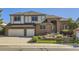 Charming two-story brick home with a well-manicured front yard and a two-car garage at 16261 W Ellsworth Ave, Golden, CO 80401