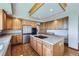 Spacious kitchen features stainless appliances, stone countertops, and wood flooring at 16261 W Ellsworth Ave, Golden, CO 80401