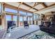 Bright living room boasts a wall of windows and balcony access with coffered ceilings at 16261 W Ellsworth Ave, Golden, CO 80401