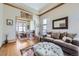Cozy living room with hardwood floors, a comfortable sofa, and an open view to the dining room at 16261 W Ellsworth Ave, Golden, CO 80401
