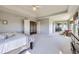 Bright main bedroom with tray ceilings leads to an en-suite bathroom at 16261 W Ellsworth Ave, Golden, CO 80401