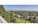 Elevated view of a neighborhood nestled among lush trees and offering stunning mountain views at 16261 W Ellsworth Ave, Golden, CO 80401