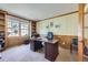Well-lit office space with a large desk, bookshelves, and a comfortable chair at 16261 W Ellsworth Ave, Golden, CO 80401