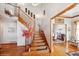 Elegant wooden staircase with a view into the dining room at 16261 W Ellsworth Ave, Golden, CO 80401