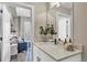 A stylish bathroom featuring a white vanity and modern fixtures with a glimpse of the living space at 3219 W 19Th Ave # 4, Denver, CO 80204