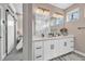 Bathroom featuring double sinks, modern lighting, and a view of an adjacent room at 3219 W 19Th Ave # 4, Denver, CO 80204