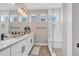 Bright bathroom featuring a double vanity, sleek fixtures, and a modern glass-enclosed shower with bench at 3219 W 19Th Ave # 4, Denver, CO 80204