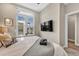 Cozy bedroom showcasing a mounted TV, natural light, and comfortable décor at 3219 W 19Th Ave # 4, Denver, CO 80204