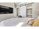 Bedroom featuring a mounted TV, a sliding door closet, and comfortable bedding at 3219 W 19Th Ave # 4, Denver, CO 80204